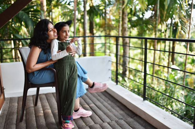 Family on a balcony overlooking greenery